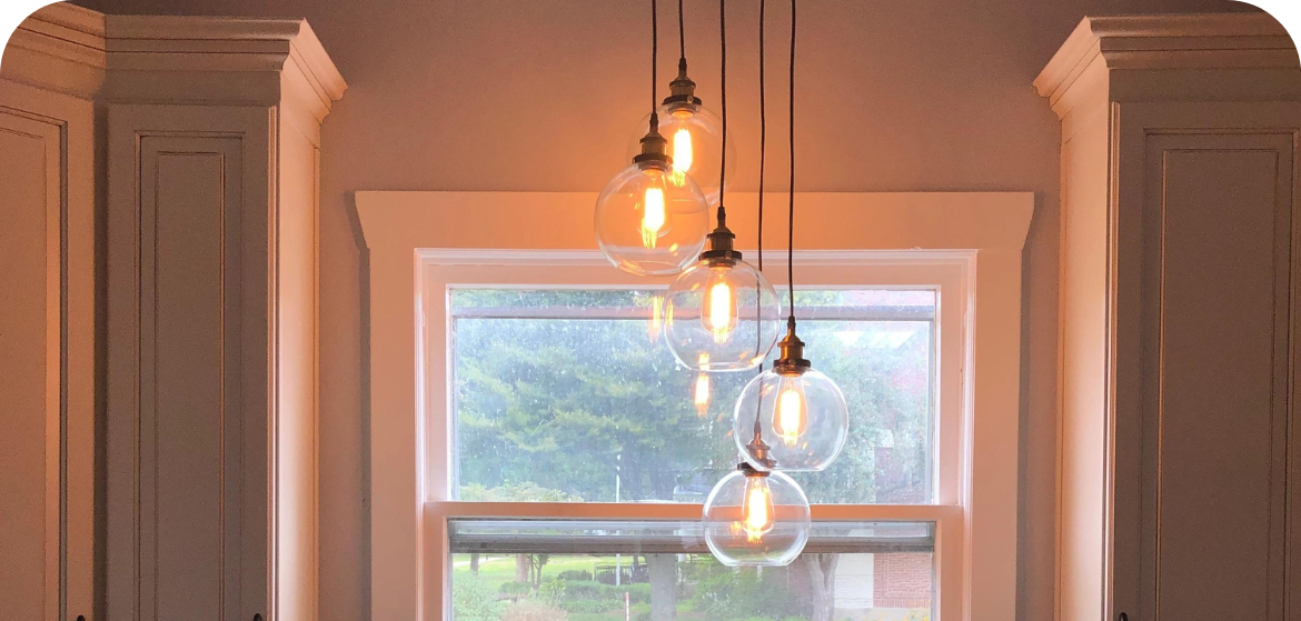 Lights hanging from ceiling above kitchen sink