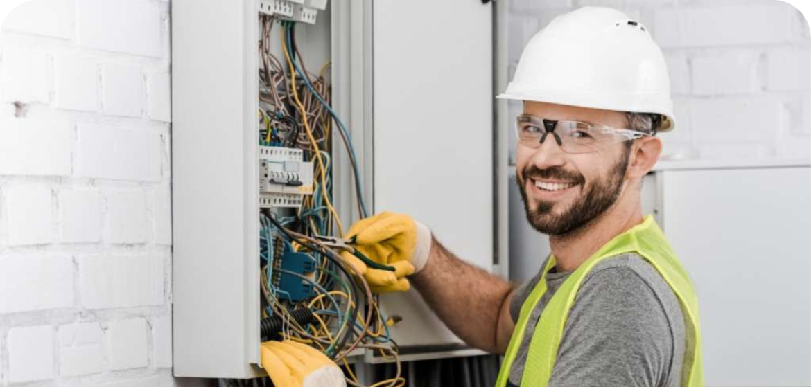 Just a guy smiling while sticking his finger into an electrical panel 